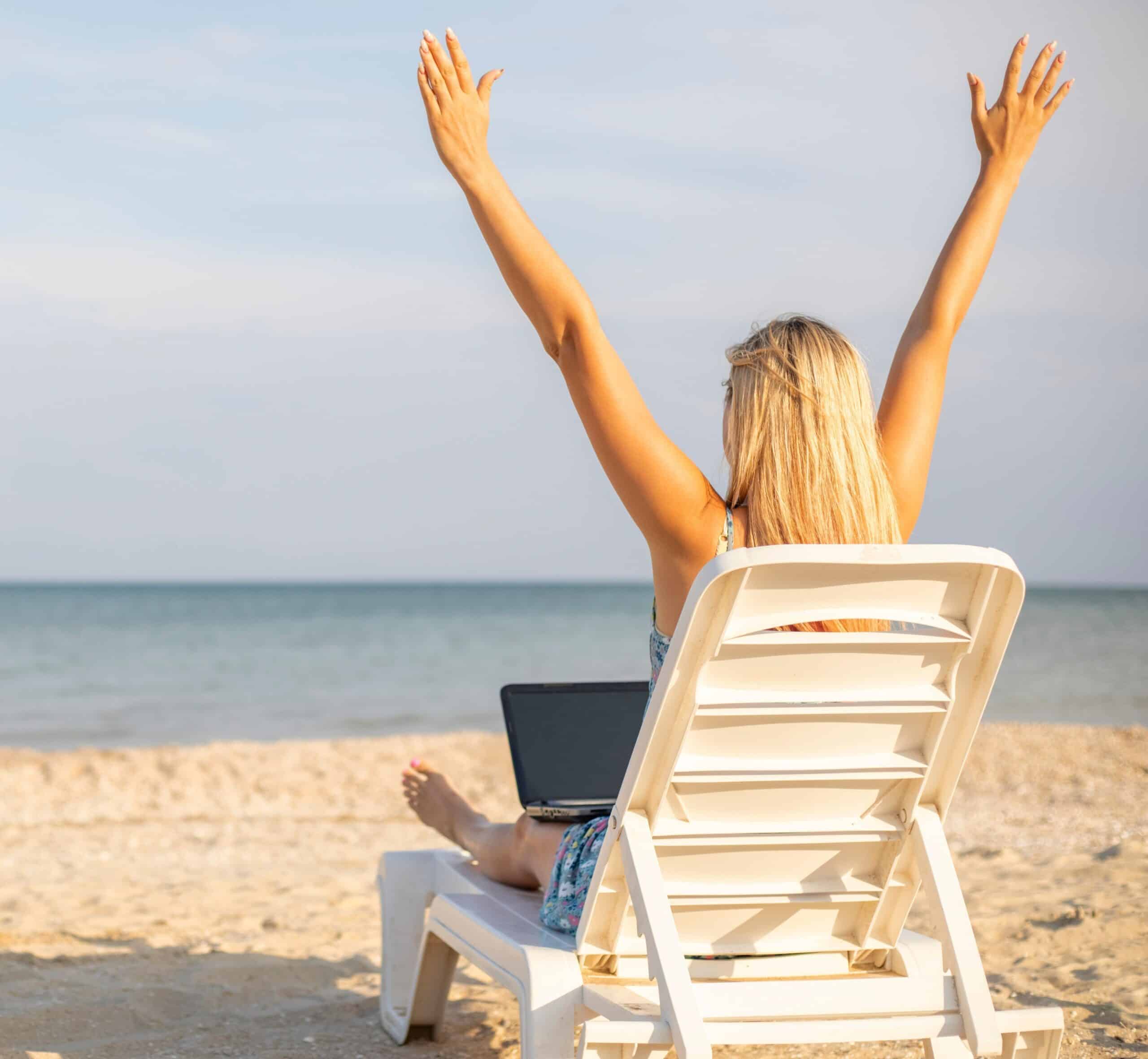 woman on beach looking at her digital documents